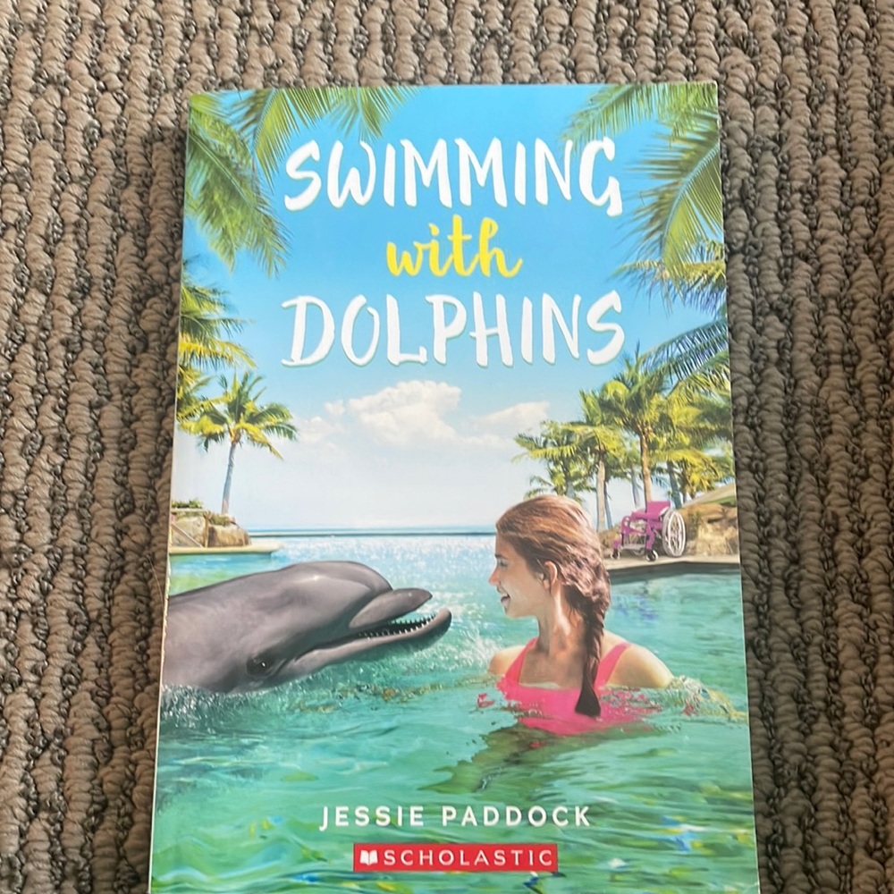 Swimming with dolphins by Jessie Paddock
